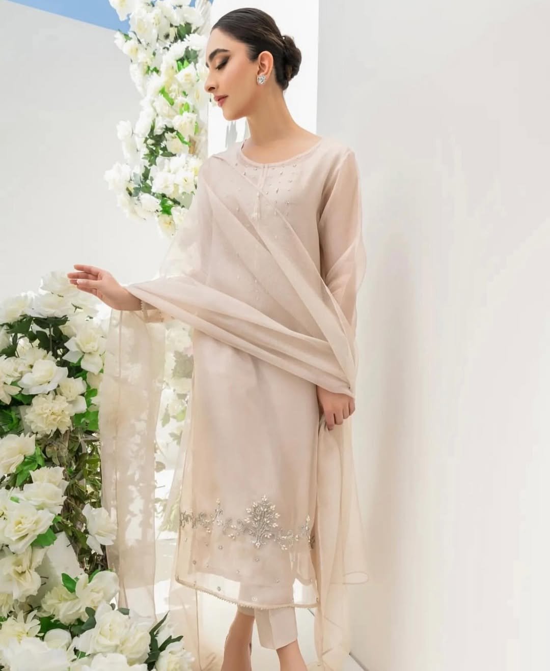 New Arrival - Pre-Booking - 4pcUnstitched - Read y-to-wearThis elegant white outfit features intricate handwork with pearls and Swarovski crystals on the shirt’s daaman, neck, and sleeves.The organza dupatta is (3)