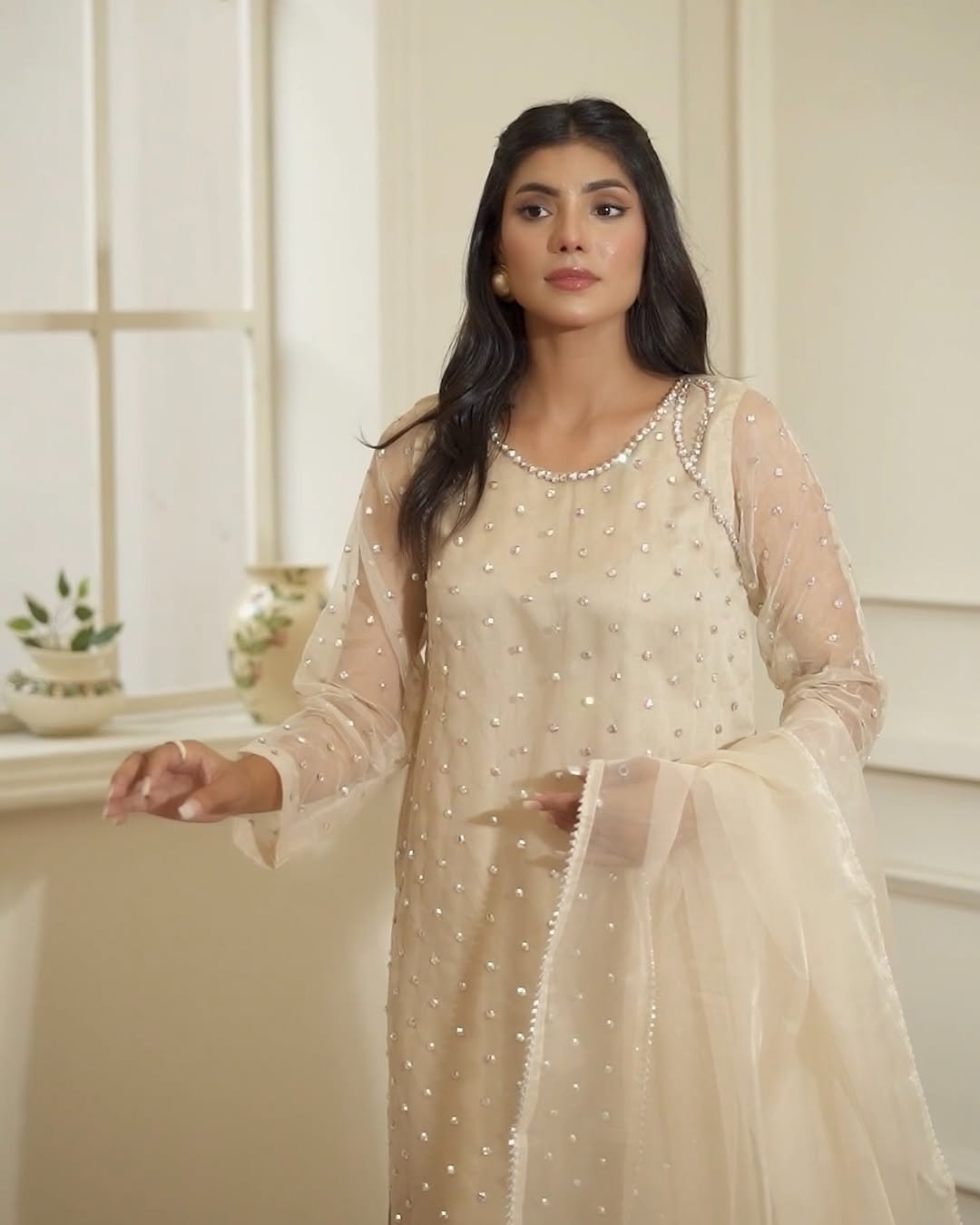 𝗕𝗲𝗶𝗴𝗲Grace meets elegance in this beige organza dress, adorned with shimmering handworked crystal flowers. A timeless winter masterpiece for your most graceful moments..Now available in store - https---vog (2)